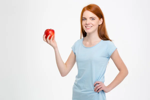 Smiling redhead woman holding apple — Stockfoto