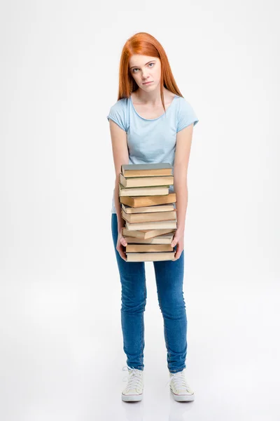 Tired exhausted woman standing and holding stack of books — 图库照片