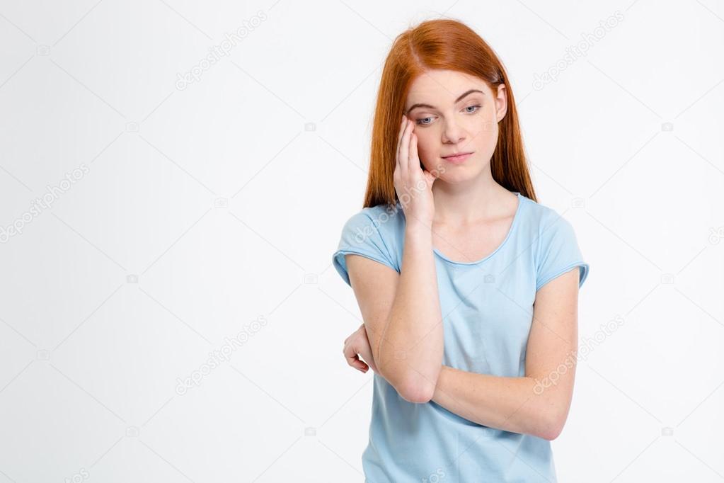 Sad depressed young female touching her temple and having headache