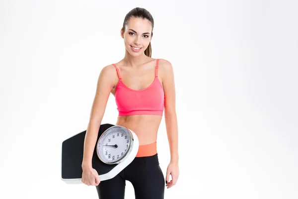 Attrative happy sportswoman posing with weighing scale — Φωτογραφία Αρχείου