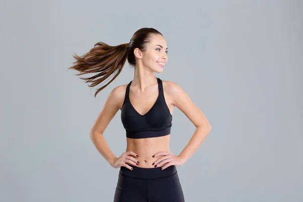 Positive cheerful fitness woman warming up and turning her head — Stock Photo, Image