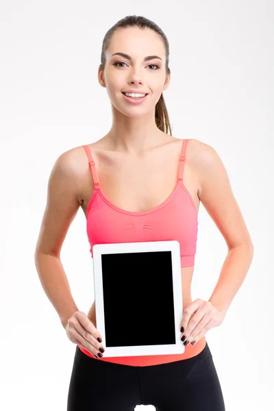 Pretty positive fitness girl holding blank tablet computer screen — Stock Photo, Image