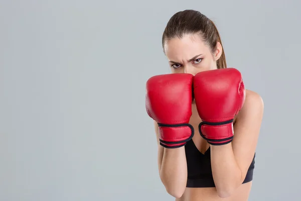 Strong intense fitness woman covered her face with boxing gloves — Zdjęcie stockowe