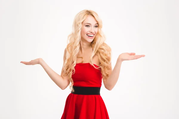 Chica positiva alegre en vestido rojo con copyspace en las palmas —  Fotos de Stock