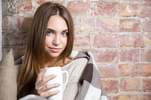 Femme en plaid chaud tenant tasse avec thé chaud — Photo