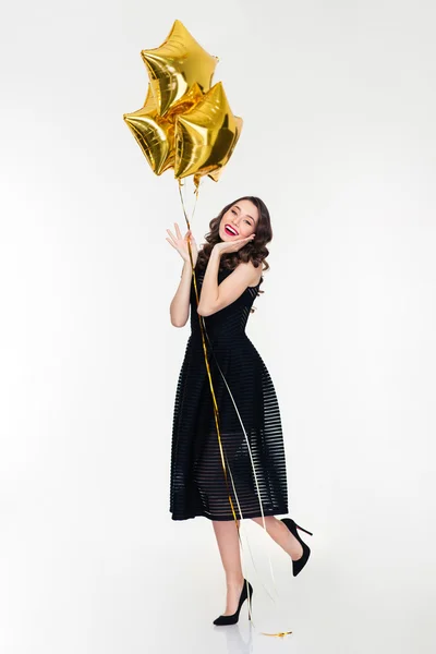 Charming smiling young curly female holding balloons — Φωτογραφία Αρχείου