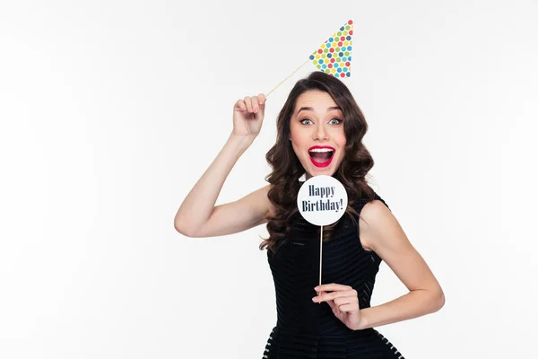 Smiling joyful pretty curly woman posing with birthday props isolated — Zdjęcie stockowe