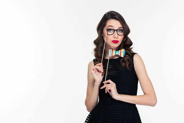 Amusing beautiful curly woman with fake bowtie and glasses booth — Stock fotografie