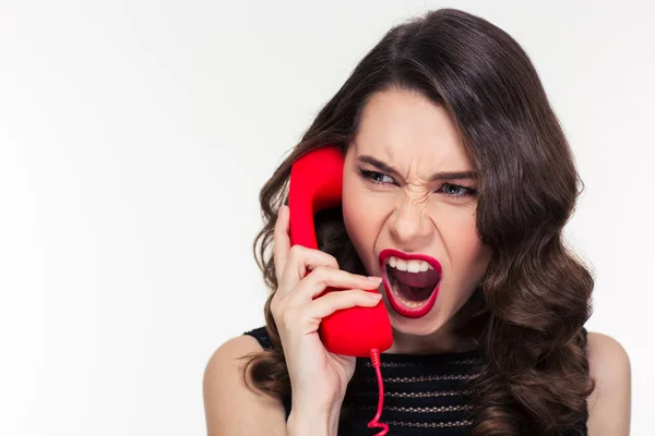 Angry woman in retro style screaming and talking on telephone — 스톡 사진