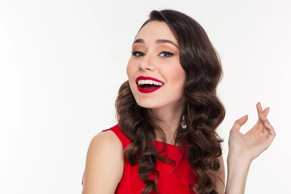 Cheerful woman in red dress looking at camera — Stock fotografie