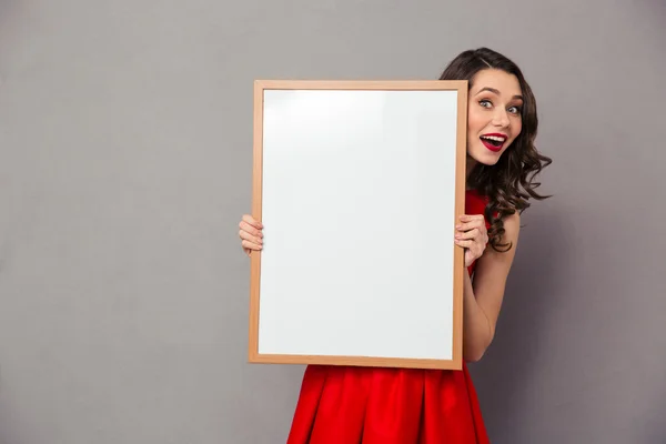 Cheerful woman holding blank board — Stock Photo, Image