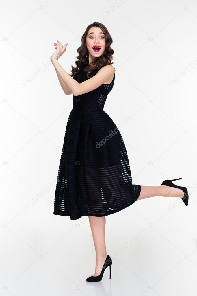 Beautiful woman throwing something with both hands to the side