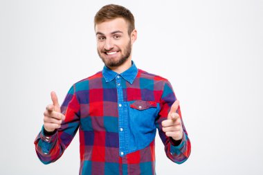 Smiling man pointing finger at camera