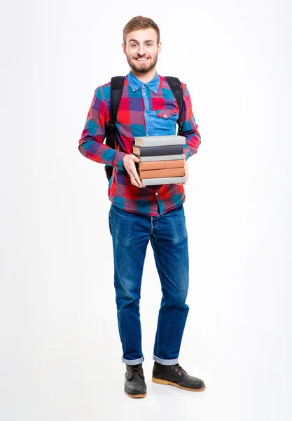 Sonriente estudiante masculino sosteniendo libros —  Fotos de Stock