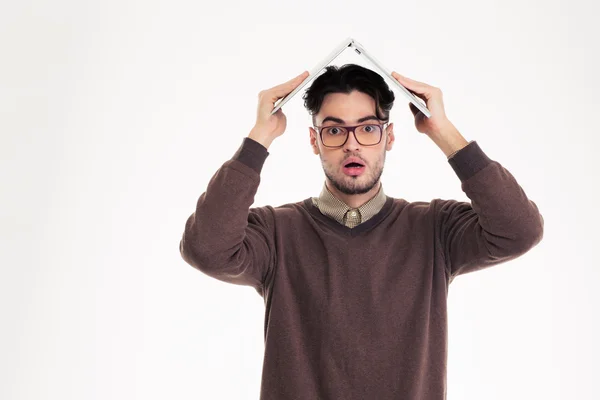 Shocked man holding laptop computer over head — Stock Photo, Image