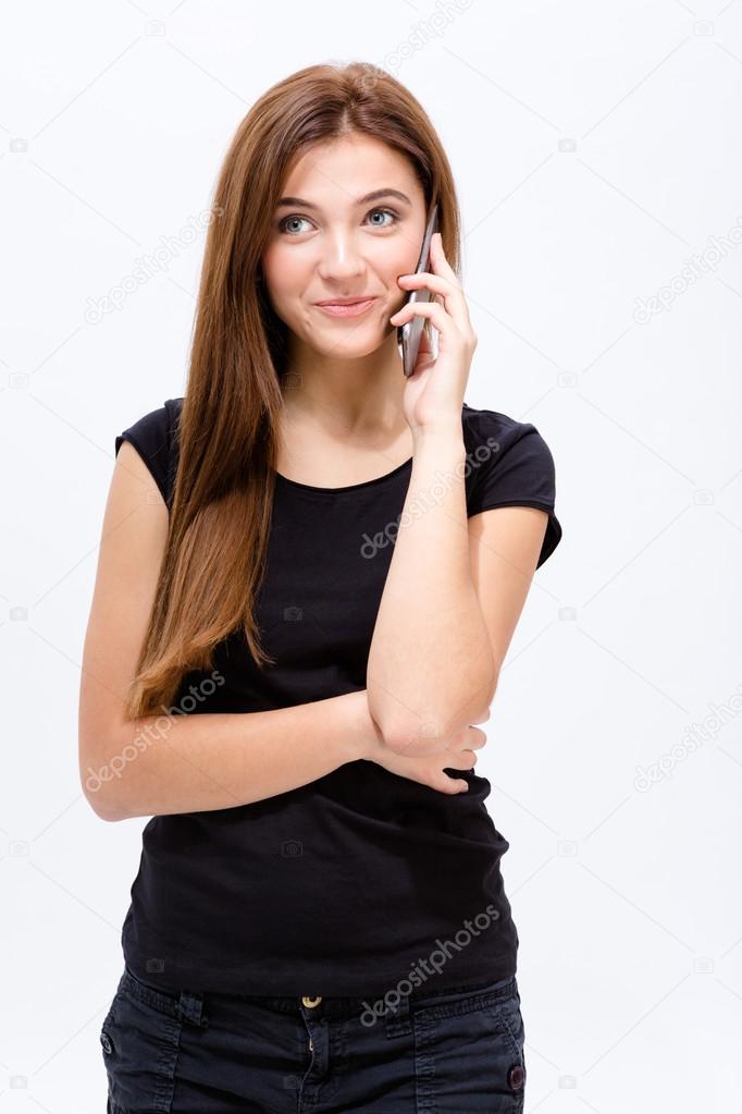 Beautiful joyful young woman talking on mobile phone