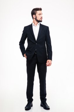 Full length portrait of a confident businessman looking away 