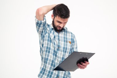 Thoughtful annoyed bearded young man scratching his head by hand