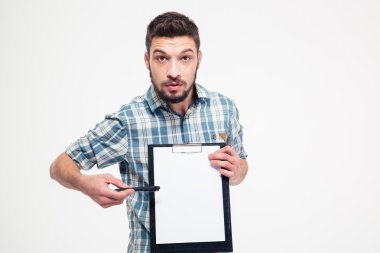 Serious handsome bearded man pointing on blank clipboard