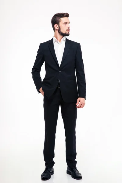 Full length portrait of a confident businessman looking away — ストック写真