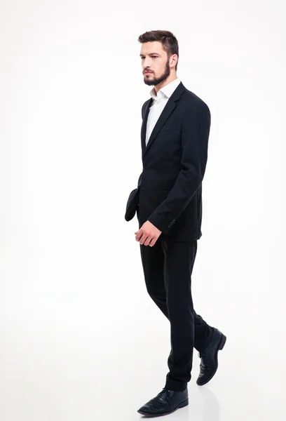 Full length portrait of a handsome businessman walking i — Stock fotografie