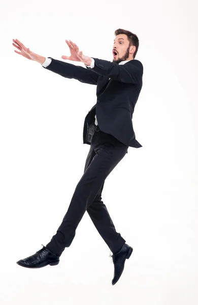 Stunned afraid businessman flying with strong wind blowing on him — Stok fotoğraf