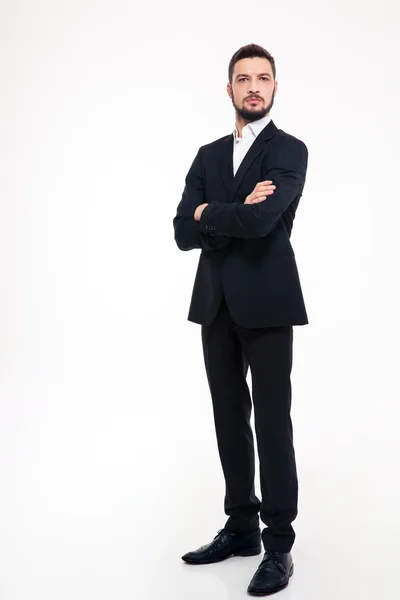 Serious businessman standing with arms folded — Stock Photo, Image