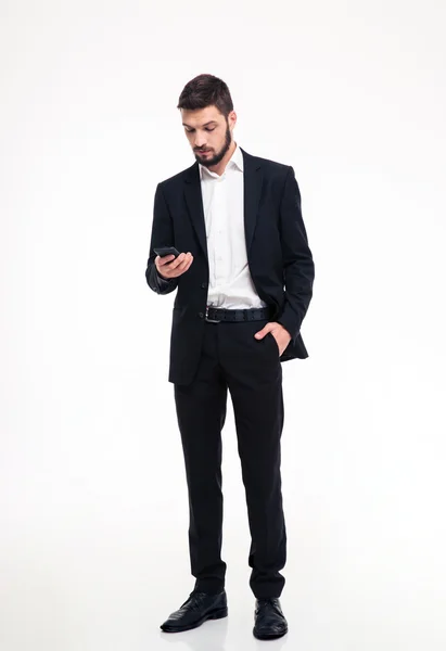 Attractive confident bearded businessman using mobile phone — Stockfoto