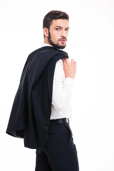 Handsome confident young businessman with beard holding jacket on shoulder — Zdjęcie stockowe