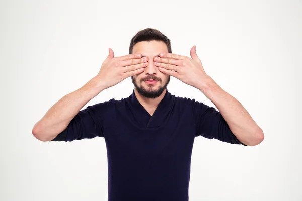 Handsome young bearded man closed eyes with hands — Stockfoto