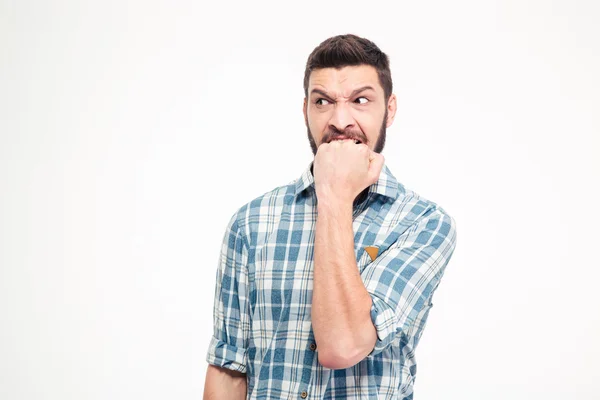 Angry irritated aggressive young bearded man biting his fist — ストック写真