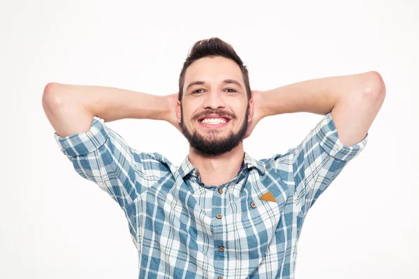 Carefree happy young bearded man with hands behind head — Stockfoto
