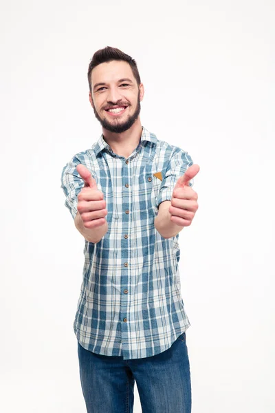 Smiling attractive young man showing thumbs up with both hands — ストック写真
