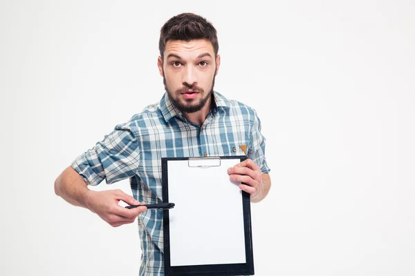 Serious handsome bearded man pointing on blank clipboard — Stock Photo, Image