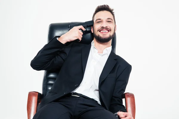 Handsome bearded business man sitting with gun at his temple — Stockfoto