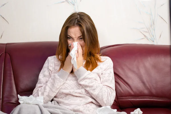 Sick ill young woman using handkerchief for her nose — Stockfoto