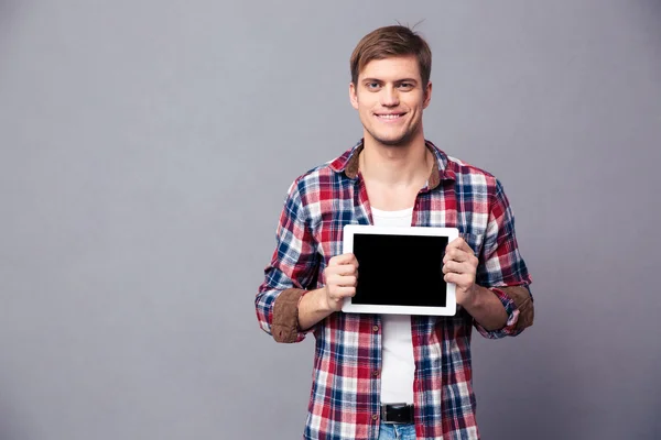 Happy attractive man in plaid shirt holding blank screen tablet — Stock Photo, Image