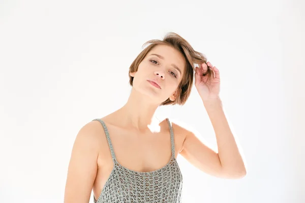 Portrait of pretty young woman touching her hair — Stock Photo, Image