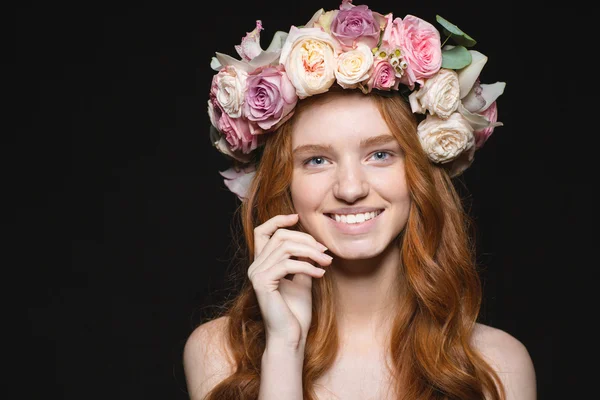 Smiling redhead woman with wreath from flowers on head — Stok fotoğraf