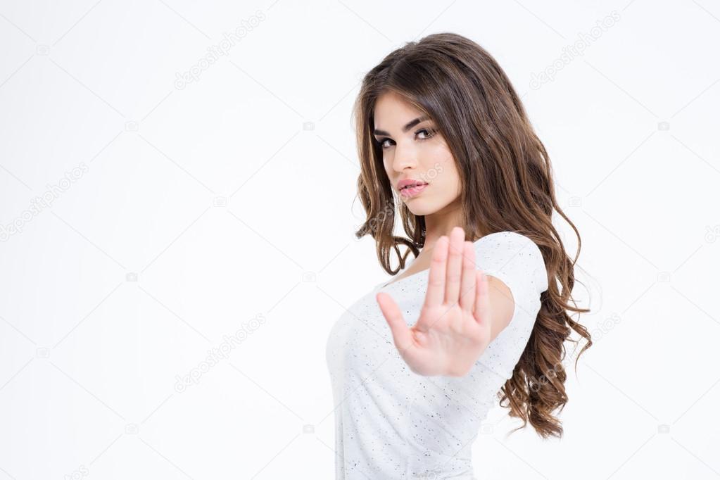 Attractive woman showing stop sign with palm