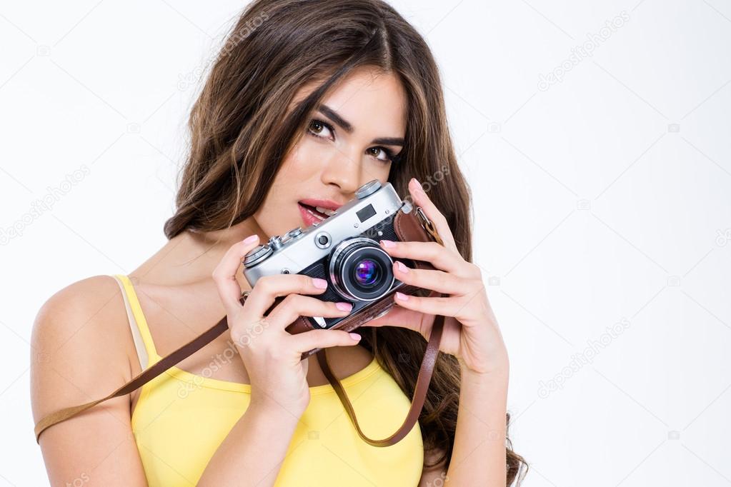 Charming woman holding retro camera
