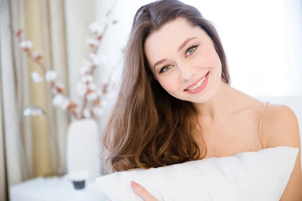 Hermosa joven feliz abrazo con almohada —  Fotos de Stock