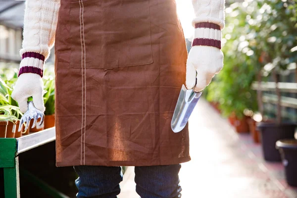 Garden tools for transplantation plants holded by hands of gardener — Stock Photo, Image