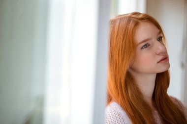Woman leaning on the wall and thinking about something 