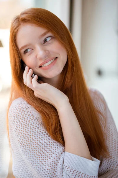 Redhead woman talking on the phone and looking at camera — Stockfoto