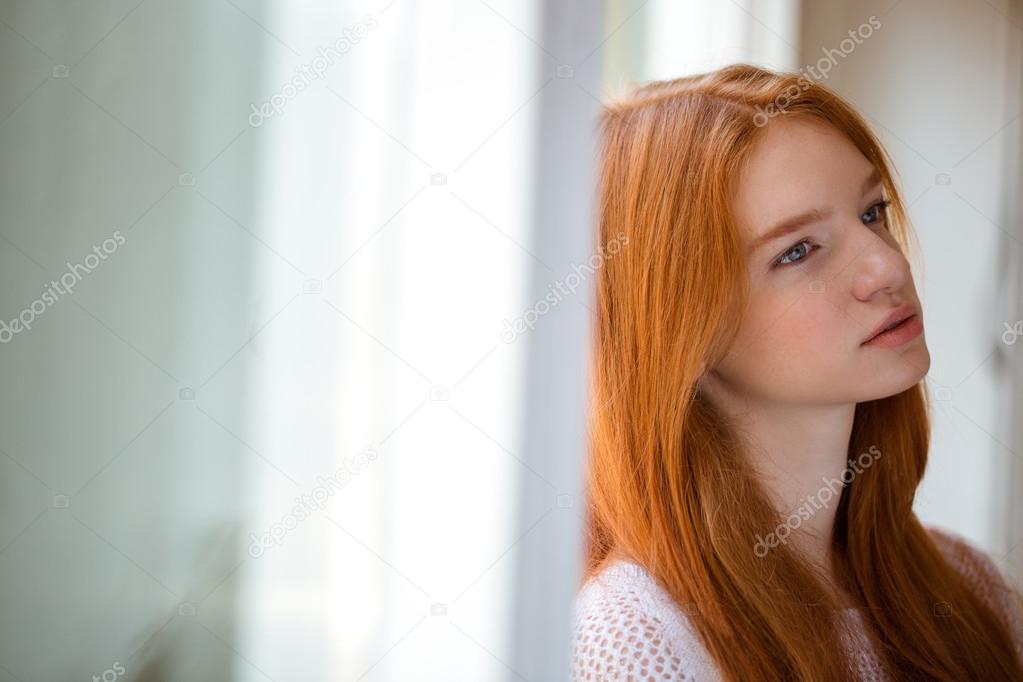 Woman leaning on the wall and thinking about something 