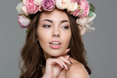 Uzağa bakıyor gül çelenk ile büyüleyici kadın