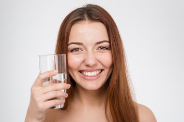 Cheerful attractive woman holding glass of water 