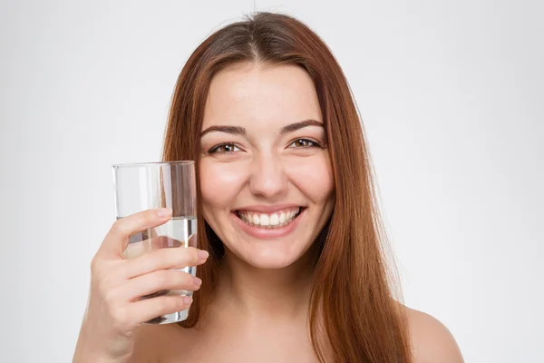 Cheerful attractive woman holding glass of water — ストック写真