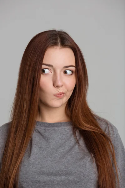 Portrait of amusing confused young woman with long hair — Stockfoto